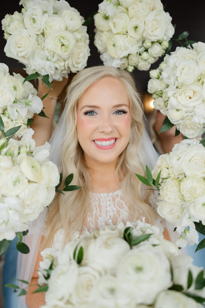 Taylor framed by flowers during her bridal portraits at Park Crest