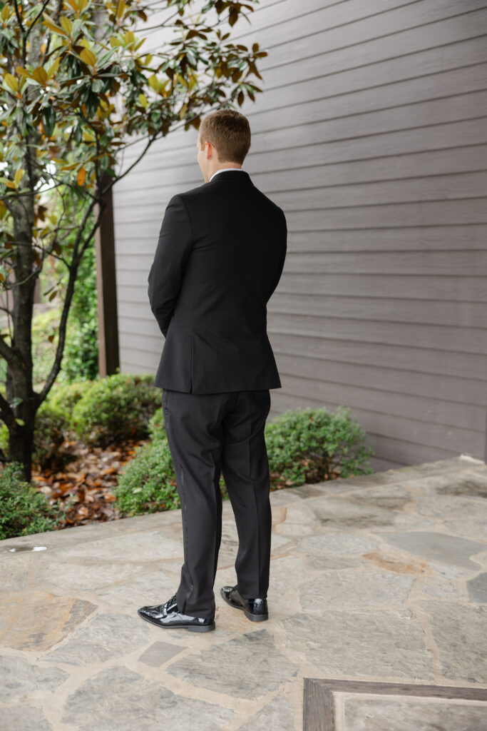 Alex waiting to see Taylor during their wedding day first look
