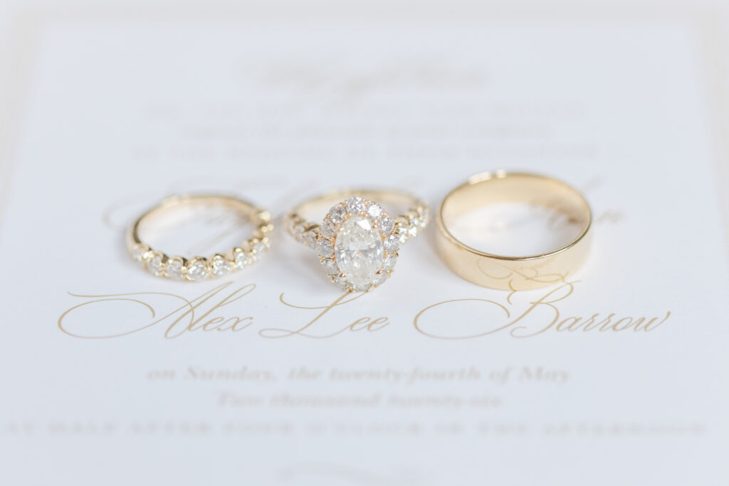 Taylor and Alex’s wedding rings styled with their invitation suite