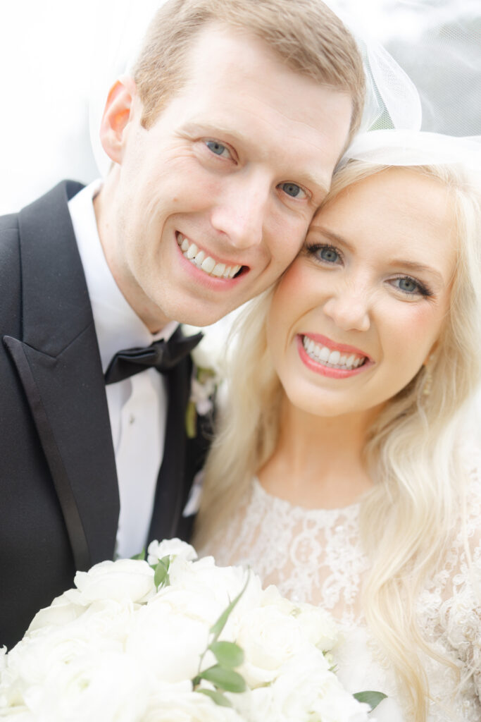 Taylor and Alex smiling together during wedding portraits in Birmingham