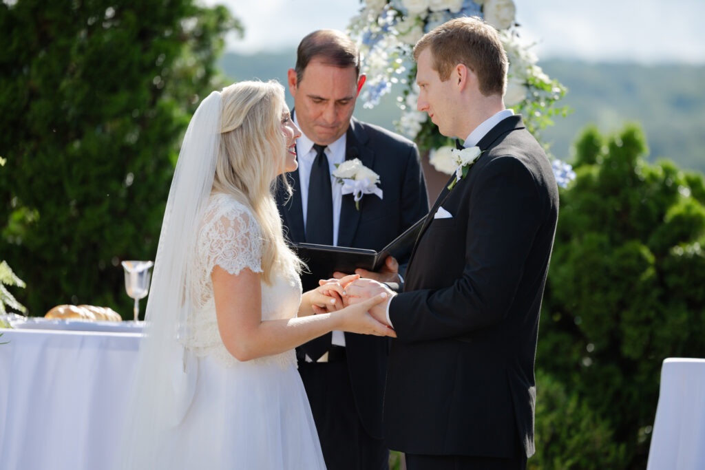 Close-up of Taylor and Alex holding hands with their wedding rings
