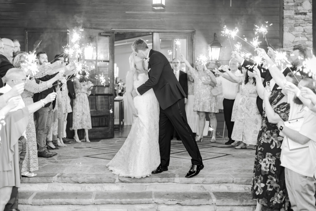 Taylor and Alex running through a sparkler exit at the end of their Park Crest wedding