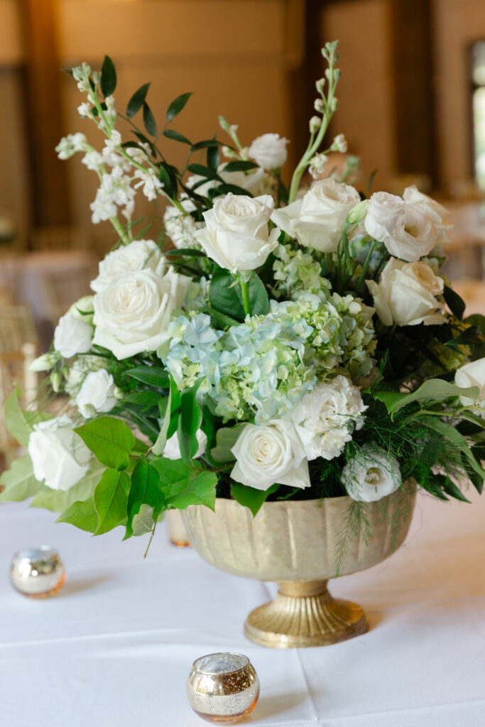 Blue and white floral centerpiece at Taylor and Alex’s wedding reception