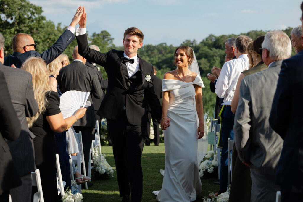 Brooke and Zach walking back down the aisle as newlyweds