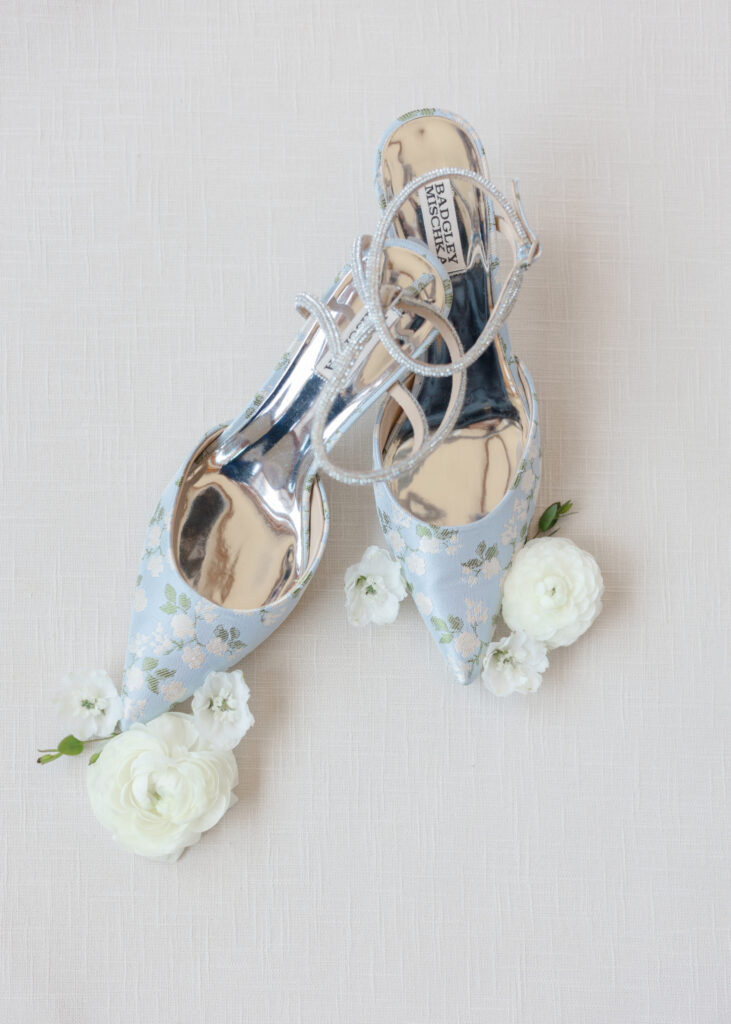 Blue floral bridal heels styled with white flowers
