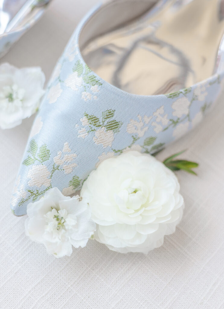 Blue floral bridal heels styled with white flowers