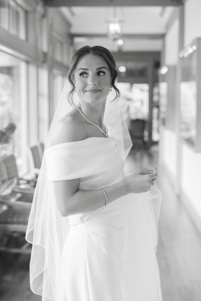 Black and white photograph of Brooke getting ready for her wedding