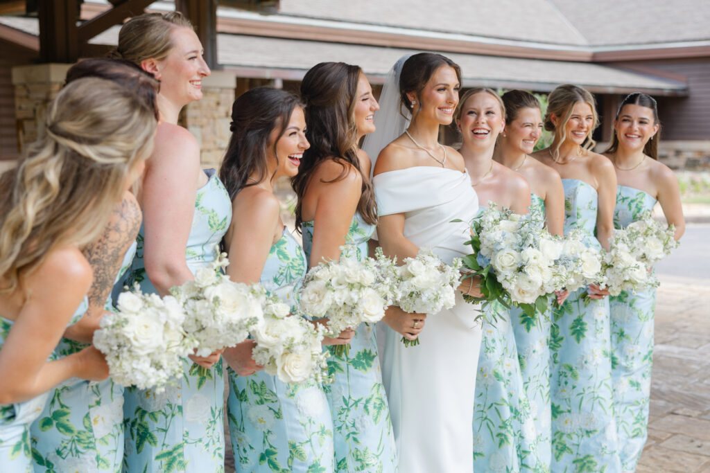 Bridesmaids wearing blue and green botanical dresses